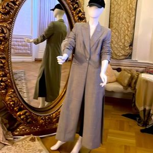 COPY - This 100% wool fully lined long jacket is high fashion with many details